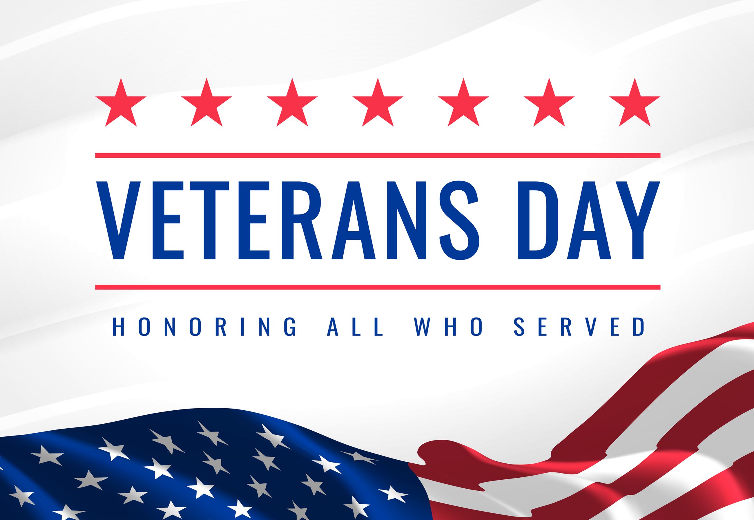 An American Flag with the words &#34Veterans Day Honoring All Who Have Served&#34