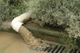 Water draining from pipe to drainage ditch